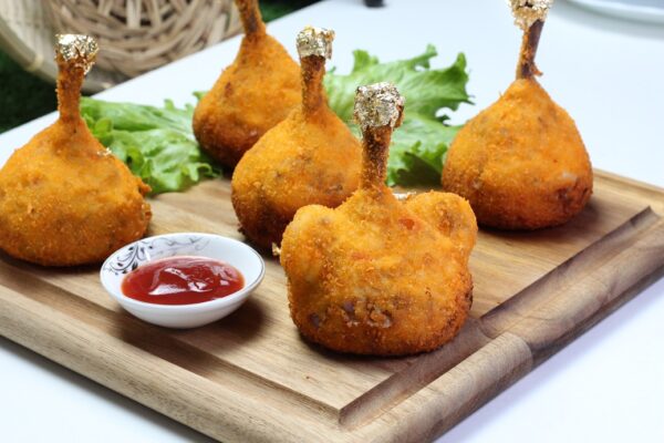 Golden-potato-wrapped chicken drumsticks on a plate